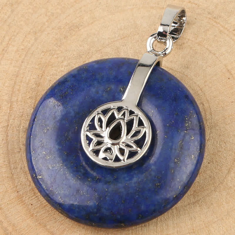 Crystal Amethyst Pink Crystal Lotus Necklace – Lapis lazuli donut pendant flat lay on wood, golden pyrite flecks and silver lotus cap