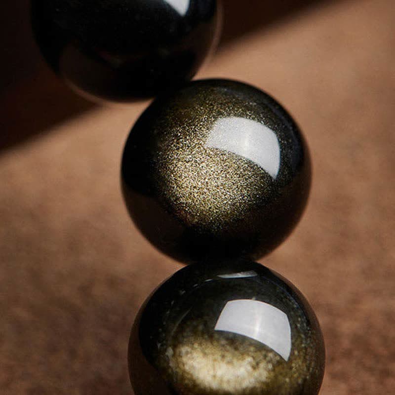 Gold Sheen Obsidian Pixiu Bracelet – macro gold sheen obsidian beads showing golden sparkle texture on brown background