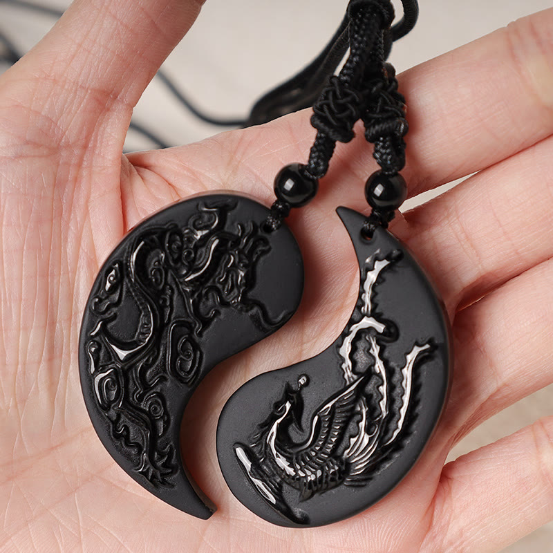 Black Obsidian Dragon Phoenix Necklace - Carved black stone couple pendants resting in hand, Protection