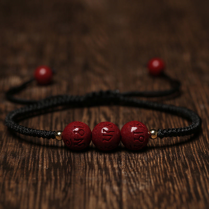 Cinnabar Om Mani Padme Hum Braided Bracelet – Black cord version with three carved red beads, cinnabar bracelet