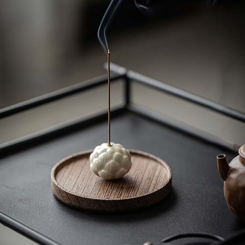 Ceramic Lotus Incense Burner with smoke on black tea tray, Japanese zen meditation