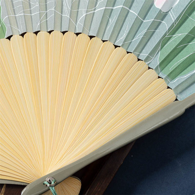 Lotus Begonia Jasmine Handheld Bamboo Folding Fan - close-up sage green ribs with lotus leaf pattern, craftsmanship