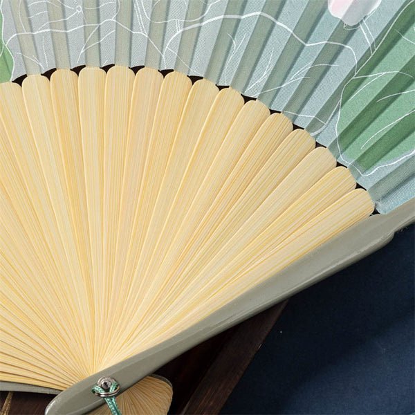 Lotus Begonia Jasmine Handheld Bamboo Folding Fan - close-up sage green ribs with lotus leaf pattern, craftsmanship