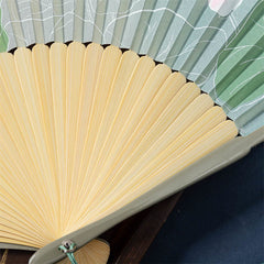 Lotus Begonia Jasmine Handheld Bamboo Folding Fan - close-up sage green ribs with lotus leaf pattern, craftsmanship