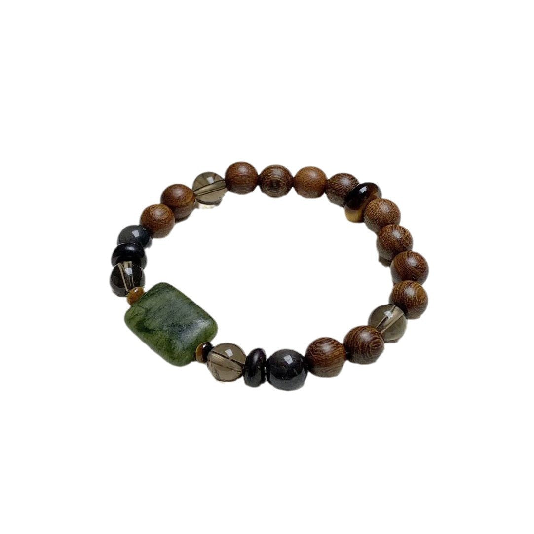 Sandalwood Wushi Bracelet – Isolated wood bead bracelet with green plaque and smoky quartz on white, spiritual gift