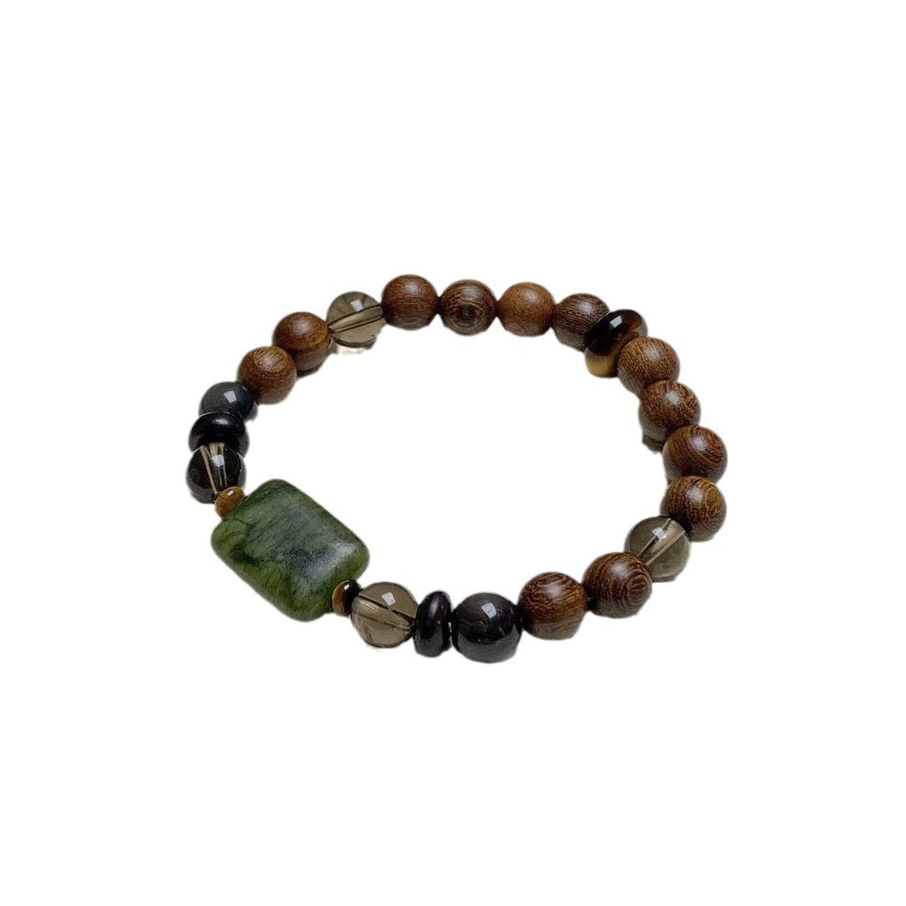 Sandalwood Wushi Bracelet – Isolated wood bead bracelet with green plaque and smoky quartz on white, spiritual gift