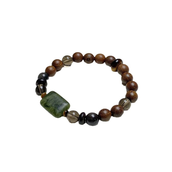 Sandalwood Wushi Bracelet – Isolated wood bead bracelet with green plaque and smoky quartz on white, spiritual gift