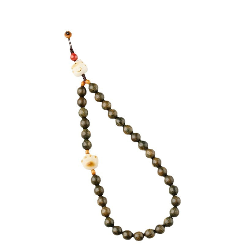 Sandalwood Cat Paw Charm – Green sandalwood bead phone lanyard with burnt cat paw and smiling cat charms on white background, product photo
