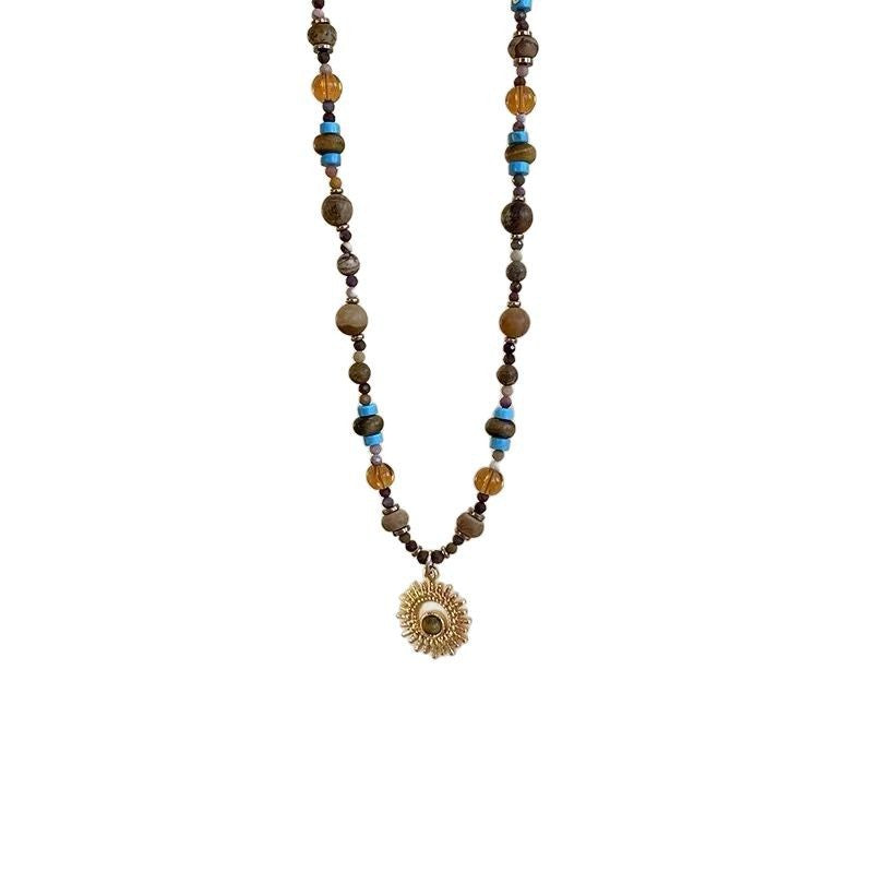 Sunflower Necklace – tiger eye and gemstone beaded necklace on white background, gold sun medallion pendant, alt text
