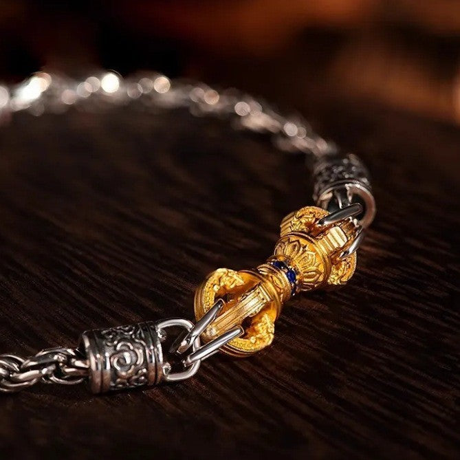 Vajra Bracelet – side angle of silver chain and gold vajra on dark wood, ornate etched beads
