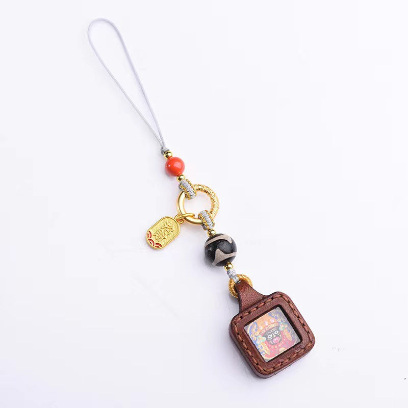 Tibetan Zakiram Thangka Amulet Keychain, close-up detail, lucky charm
