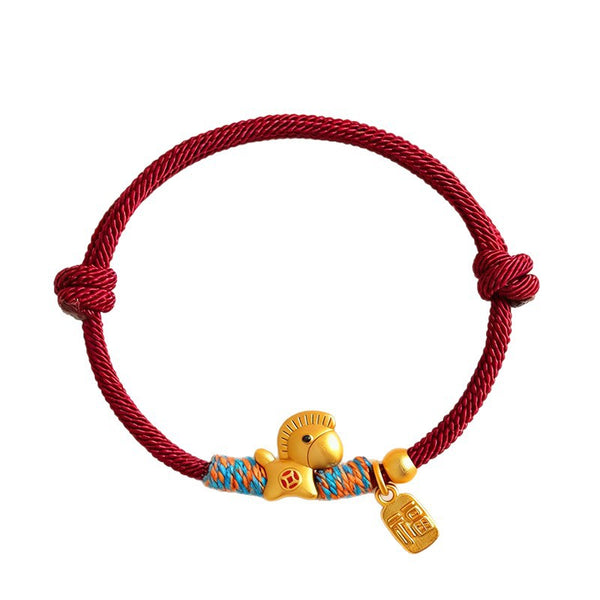 Year of the Horse Bracelet – Red cord gold horse charm isolated on white, minimalist zodiac