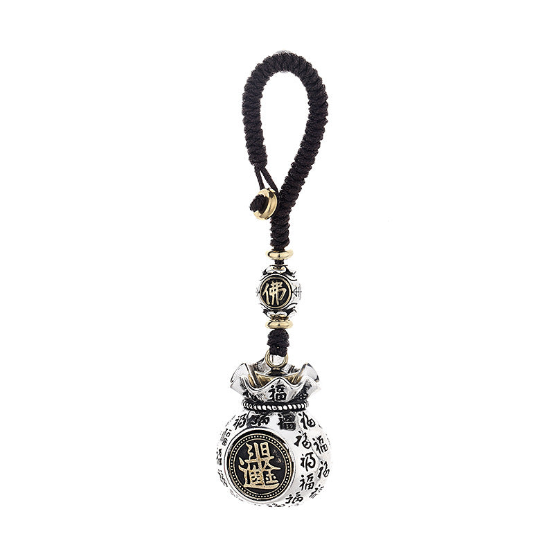 Rotating coin money pouch keychain with auspicious Fu characters covering the surface on brown background