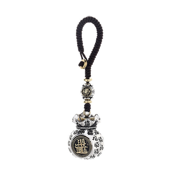 Rotating coin money pouch keychain with auspicious Fu characters covering the surface on brown background