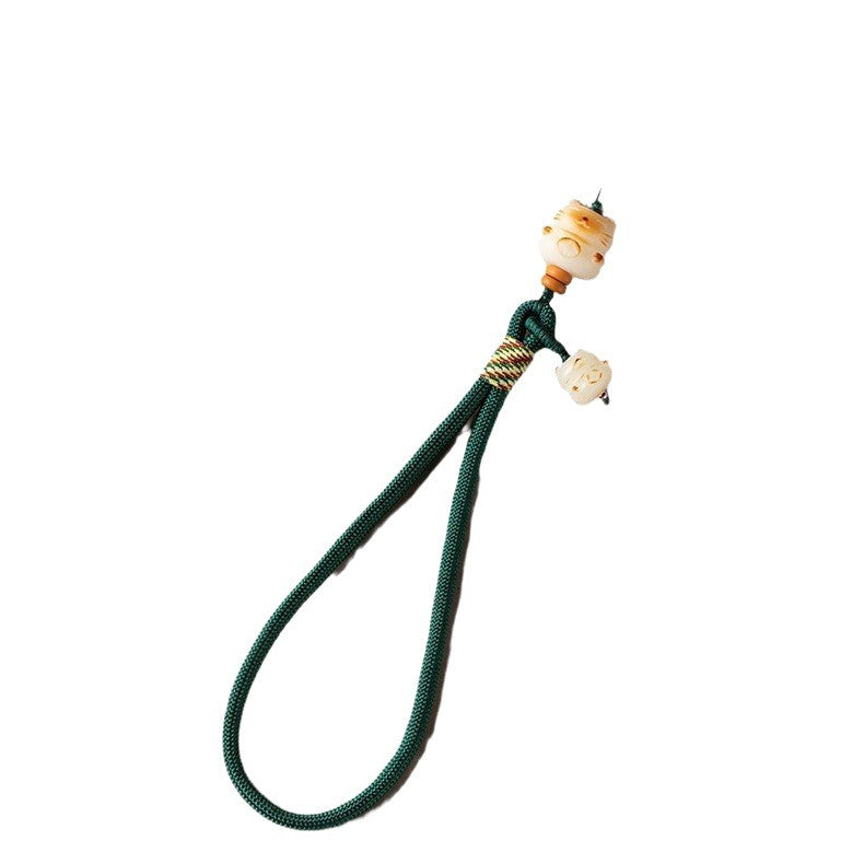 Dark green Bodhi Maneki Neko phone strap on clean white background
