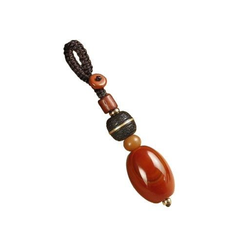 Red Agate Car Keychain – red agate with gold-ringed ebony bead isolated on white background, minimalist amulet