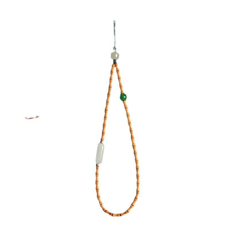 Olive Kernel Phone Chain – single bamboo bead strand with jade bar and green bead on white, minimalist phone strap