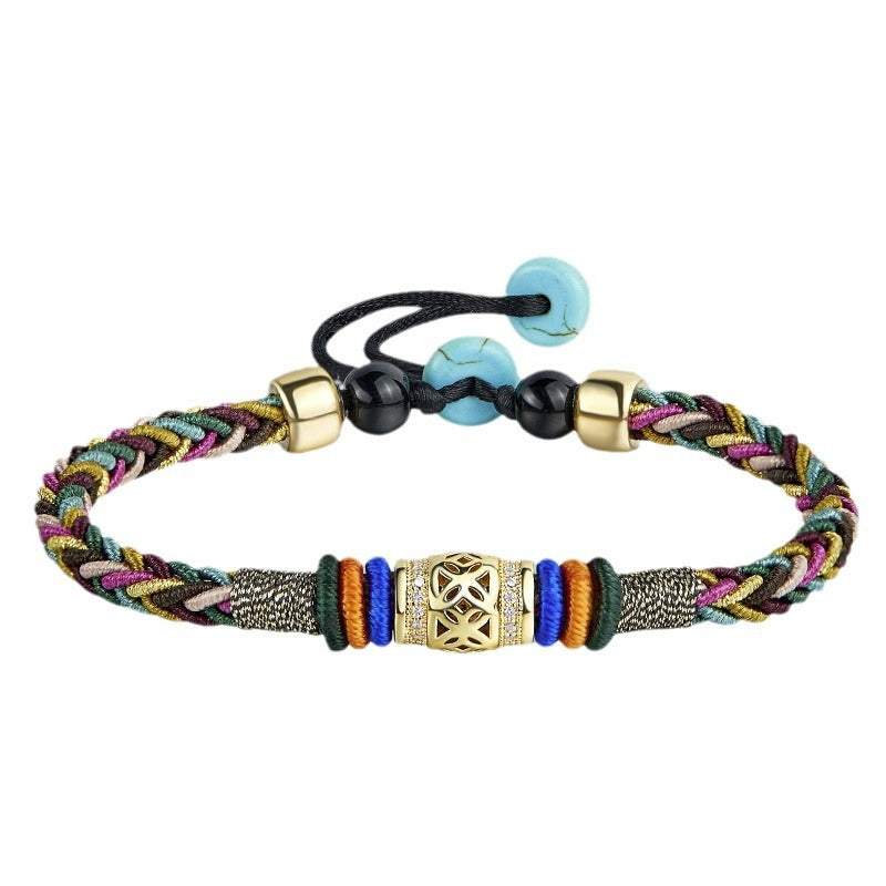 Tibetan Five-Color Bracelet – flat lay of adjustable braided band with gold centerpiece, turquoise beads, white background