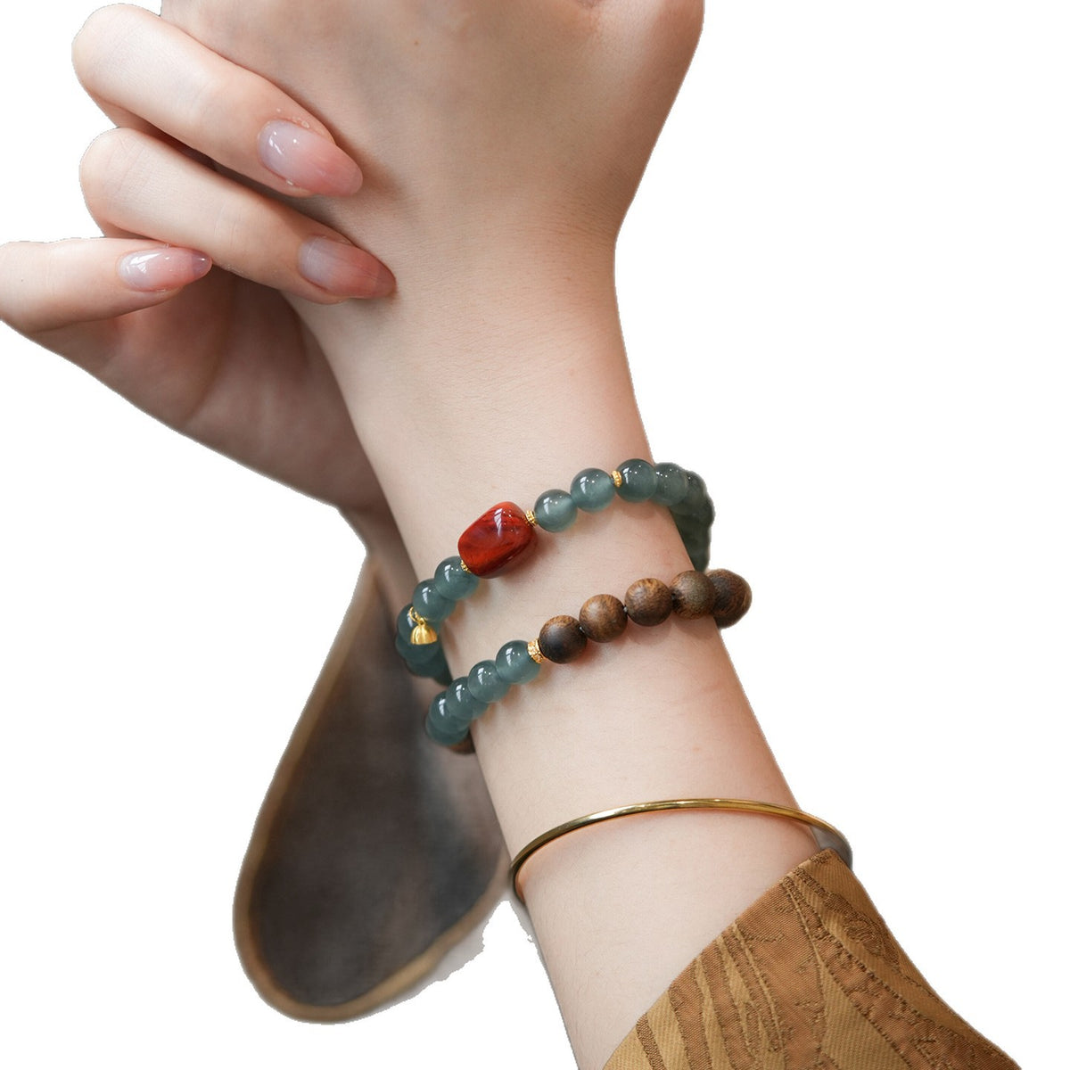 Blue Feicui Jade Two-Row Bracelet – wrist model shot on white background with beige sleeve detail