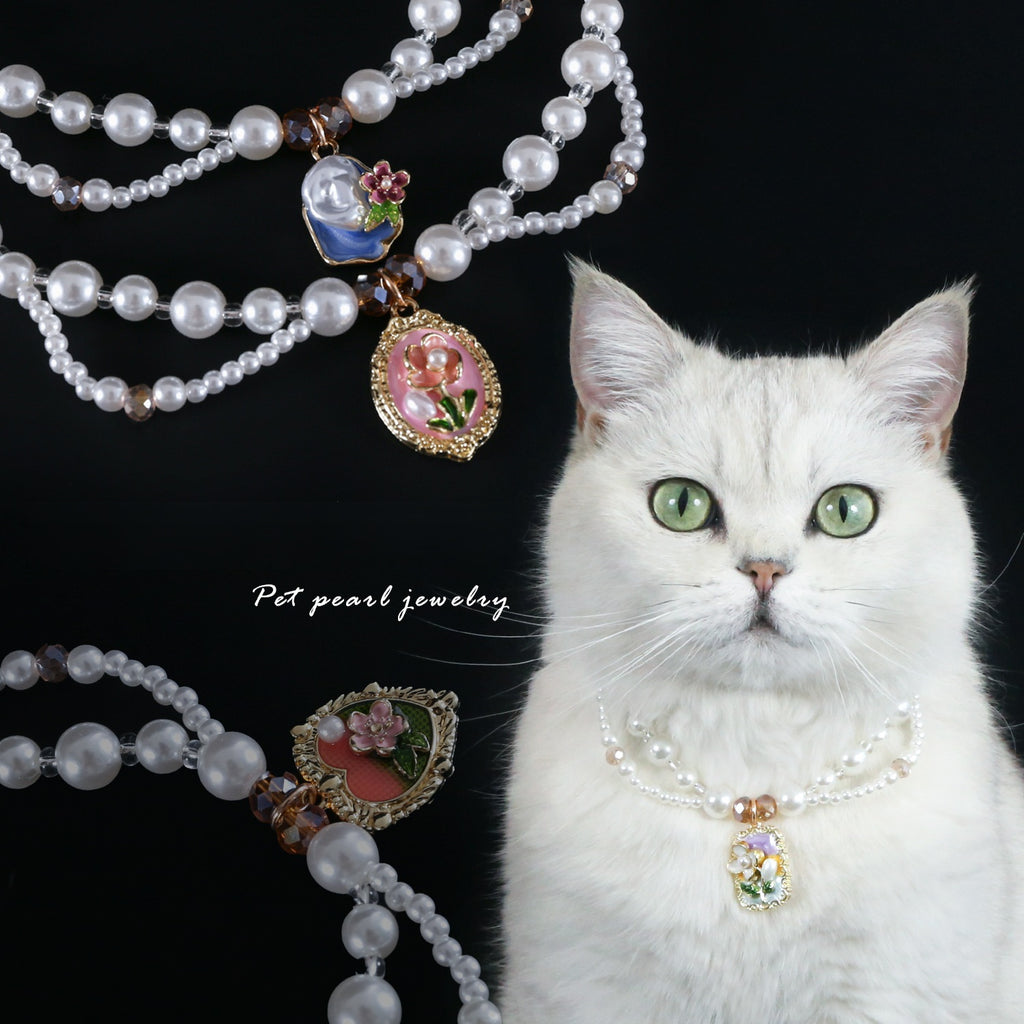 Luxury Pearl Pet Necklace – White cat wearing triple-layer pearl collar with floral enamel charms, black background