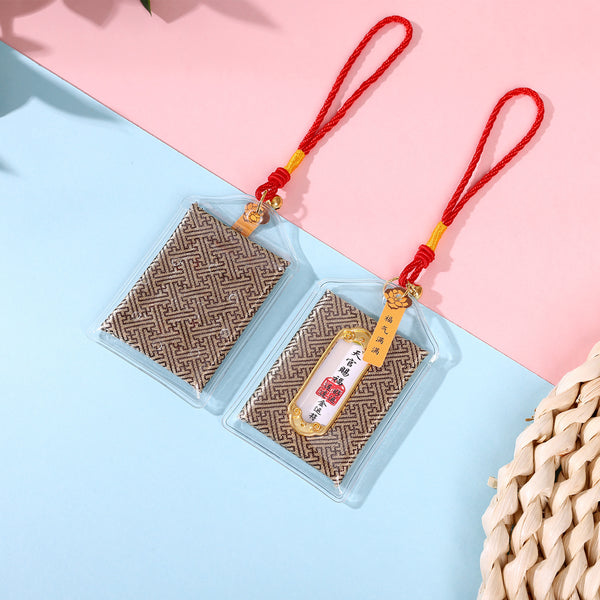 Two brown good luck amulets on pink and blue background