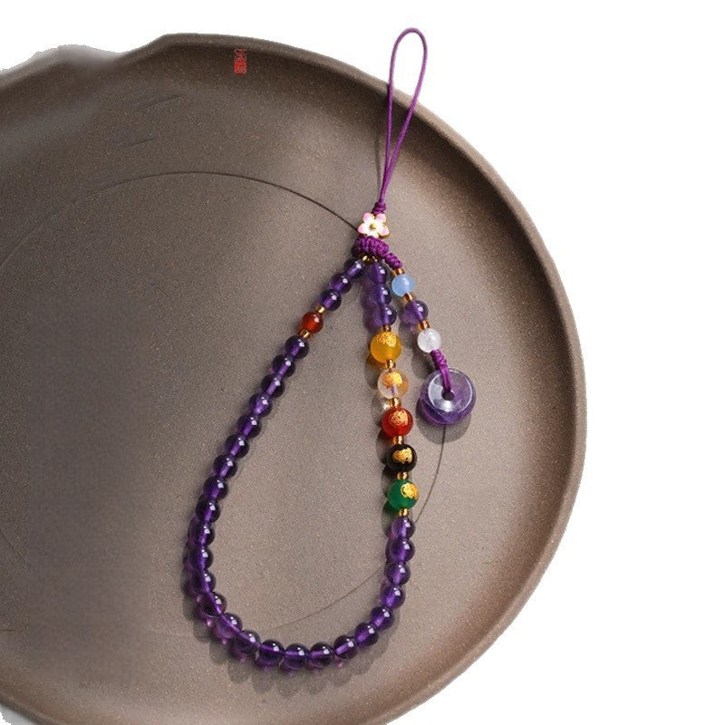 Amethyst Phone Charm – full view on dark ceramic plate with white background edge