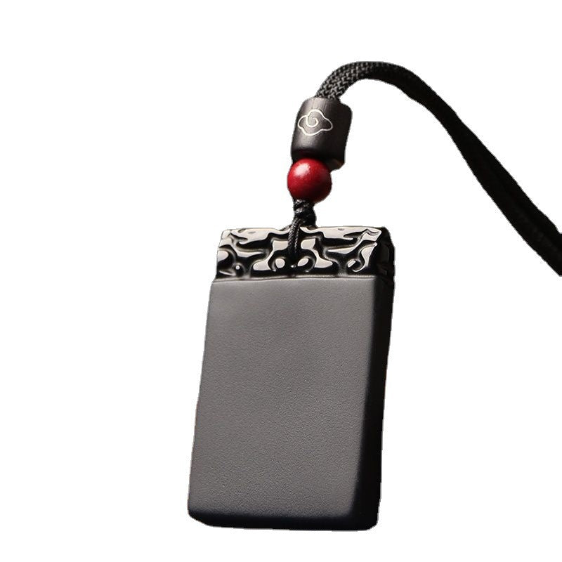 Black Obsidian Pendant – Black obsidian peace plaque pendant isolated on white background, crystal protection stone