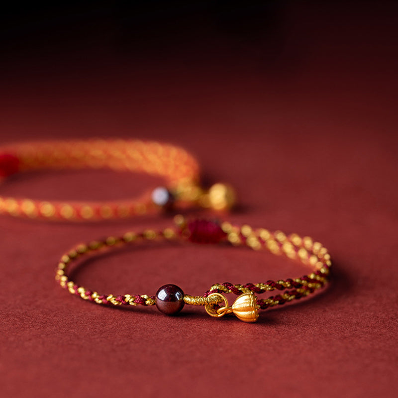 Red Gold Rope Lotus Braid Bracelet - paired bracelets with bokeh background, red string bracelet