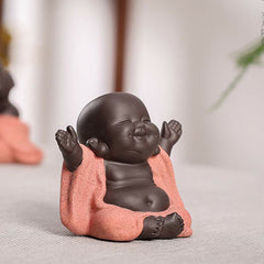 Laughing Buddha Purple Clay Maitreya Statue – chubby baby Buddha with glossy dark clay body and matte peach ceramic robe, closed-eye blissful smile