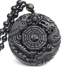 Bagua Dragon Phoenix Obsidian Pendant – Carved relief dragon and phoenix on white background, protective