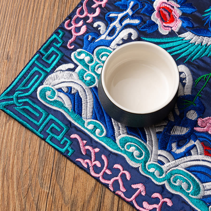 Phoenix Dragon Kirin Embroidery Tea Cup Mat - Navy mat with tea cup angled view, Functional Elegance