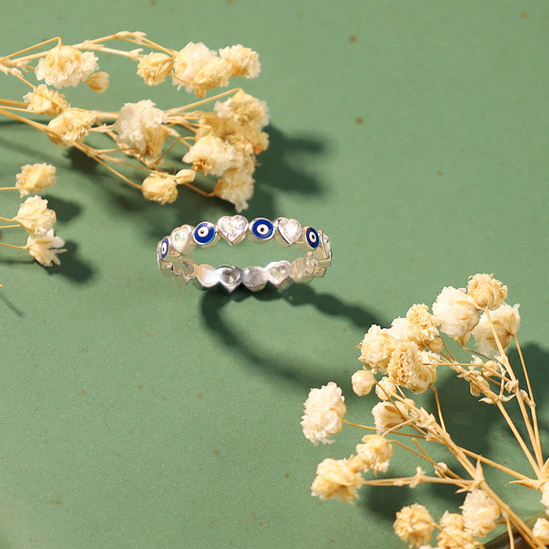 Evil Eye Bundle – Sterling silver evil eye heart alternating eternity ring on green background