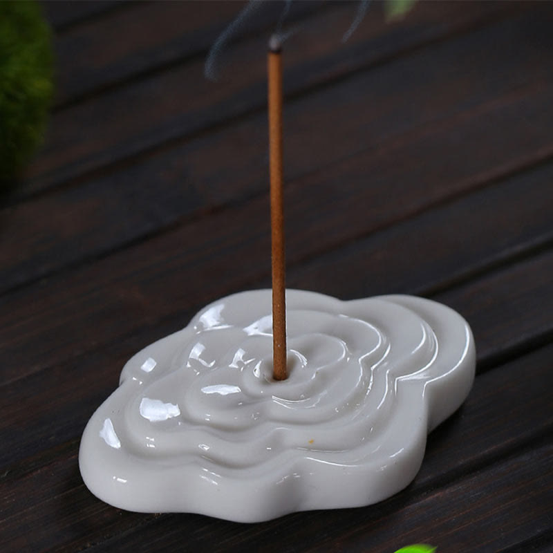 Mini Auspicious Clouds Ceramic Incense Burner – white cloud-shaped holder with burning incense and smoke on wooden slats, ceramic incense burner