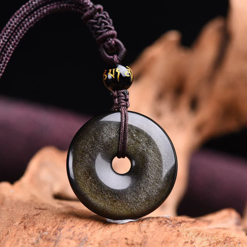 Obsidian Protection Set – golden obsidian donut closeup natural wood, protection amulet detail