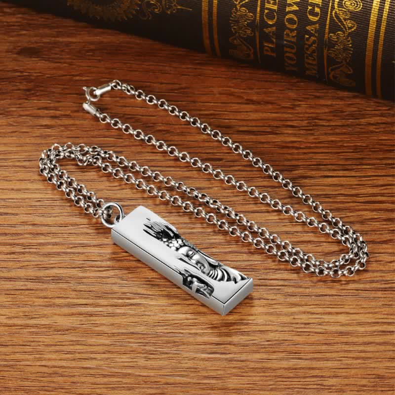 Tathagata Buddha Copper Amulet Necklace – full silver chain and Buddha pendant flat on wood with vintage books, flatlay