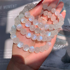 Natural Moonstone Lotus Love Bracelet - stacked strands on hand in window light, crystal beads