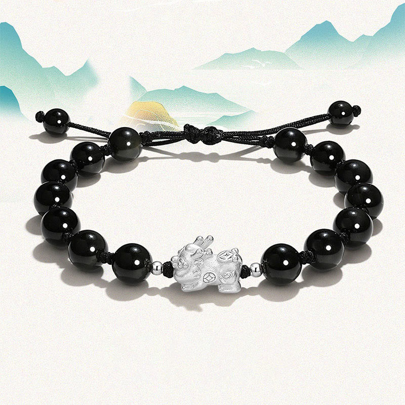 Black Obsidian PiXiu Bracelet – Black beaded bracelet with silver PiXiu charm, mountain backdrop