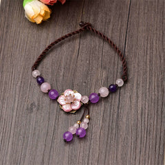Amethyst Rose Quartz Crystal Charm Healing Anklet - Yin-Yang carved black stone bracelet on dark slate surface, flat lay p...