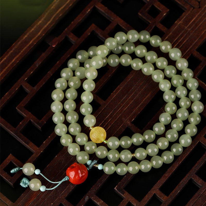 Jade Agate Buddha Bracelet - Close-up of red agate bead texture and amber highlights, healing wristband