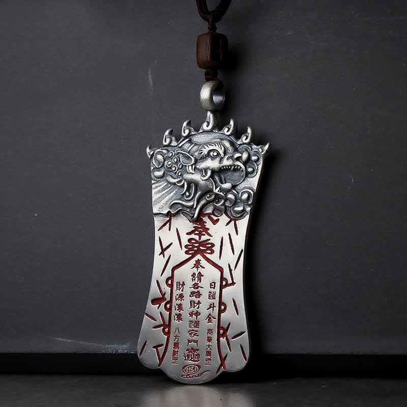 Bagua PiXiu Necklace – Silver talisman with PiXiu head and red cinnabar inscriptions, dark cord, grey wall
