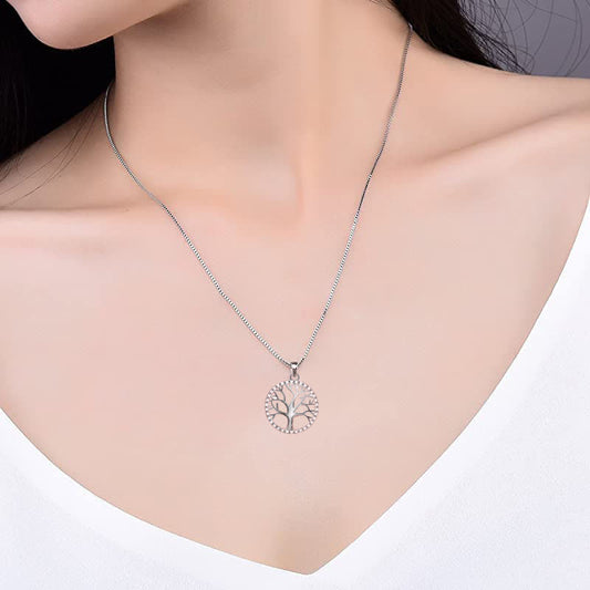 Tree of Life Sterling Silver Necklace – worn on model against white top, sterling silver pendant at collarbone, lifestyle
