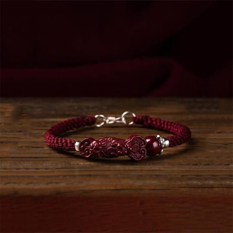 Handcrafted PiXiu Cinnabar Wealth Luck Braided Bracelet – bracelet on rustic wooden table, warm ambient lighting