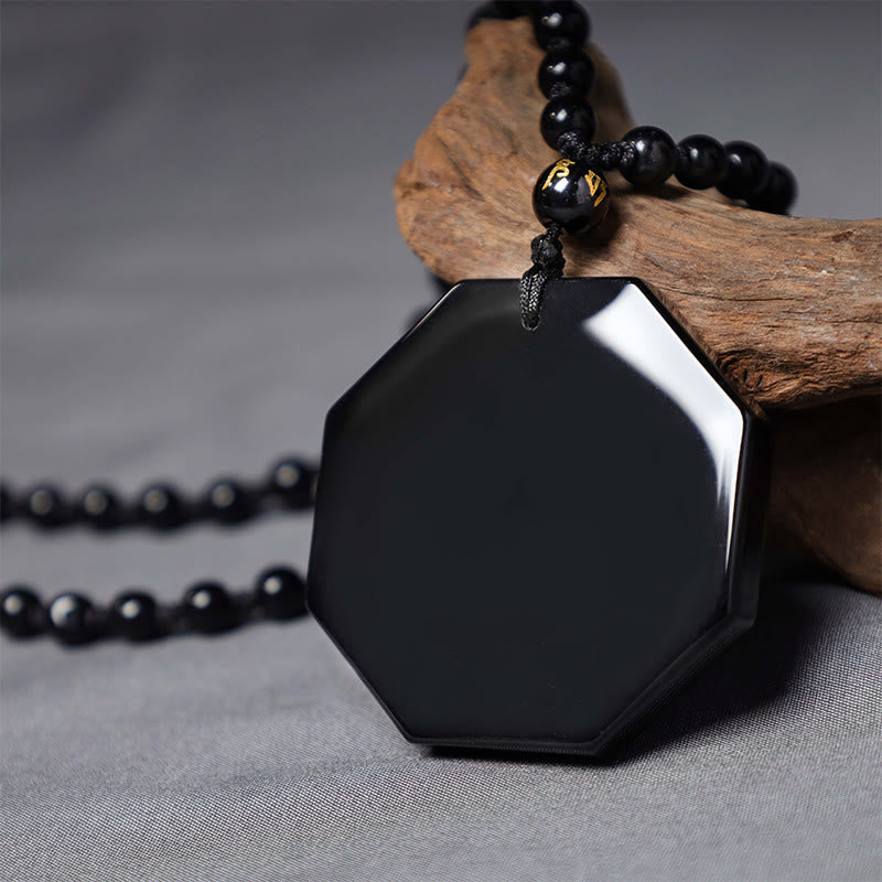 Black Obsidian Yin Yang Pendant Necklace - close-up of glossy octagonal pendant with beveled edges, obsidian bagua jewelry detail