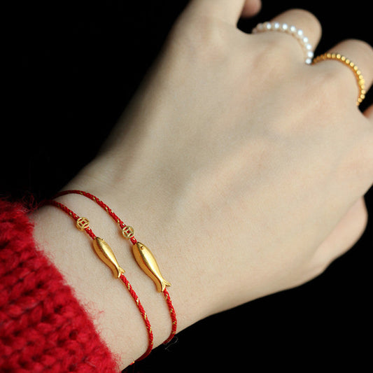 14K Gold Plated Koi Braided Bracelet – side view of 14K gold plated koi charm, braided red cord, wealth bracelet