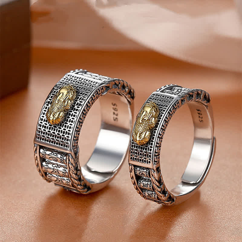 Feng Shui PiXiu Wealth Prayer Wheels Couple Ring – pair of rings close-up on warm surface showing gold PiXiu accents, adjustable open band