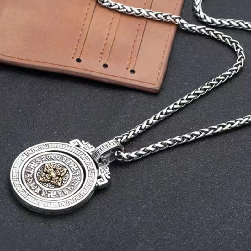 Double Dorje Vajra Rotatable Necklace – silver pendant with gold center beside leather wallet, men necklace