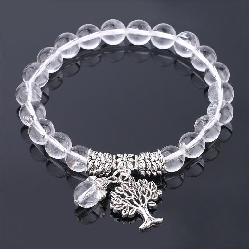 Tree of Life clear quartz bracelet with transparent crystal beads, silver-toned spacers, tree of life pendant and clear bead dangle charm.