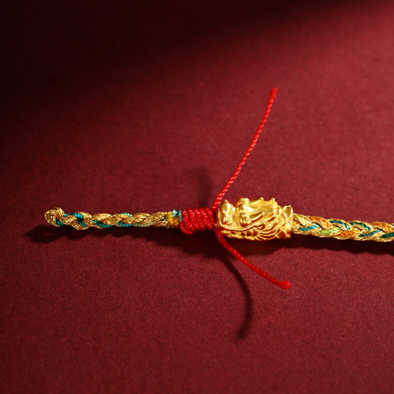 Colorful Dragon Carved Braided Bracelet – Dragon head charm with red cord knot, low-angle close-up, Protective