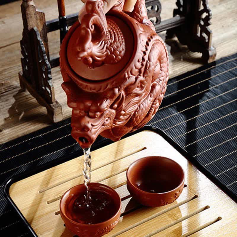 Vintage Dragon Phoenix Purple Clay Teapot – hand-poured dragon teapot streaming tea into cups on bamboo drainage tray, gongfu