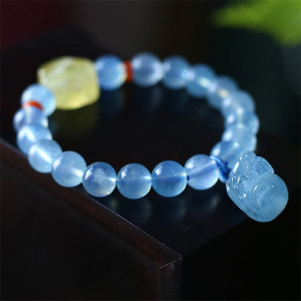 Aquamarine PiXiu Bracelet – Side view on black edge showing blue PiXiu charm and beads, serenity jewelry